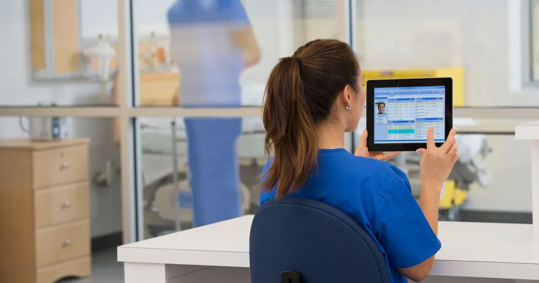 Healthcare provider in the hospital setting looking at a tablet Healthcare provider in the hospital setting looking at a tablet